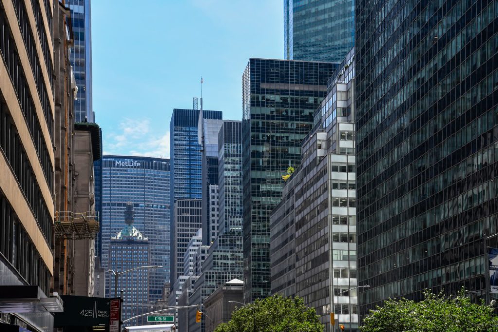 low-angle-view-of-park-avenue-in-manhattan-with-office-buildings-and-metlife-building-on-background_t20_V7zeBk
